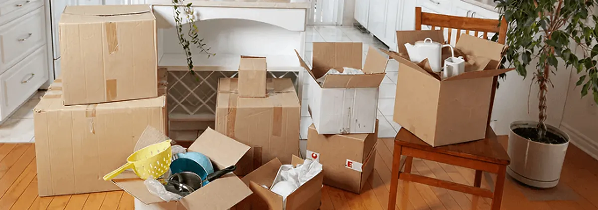 Packed moving boxes and household items in a kitchen before move-out or move-in cleaning, Springfield, MO.